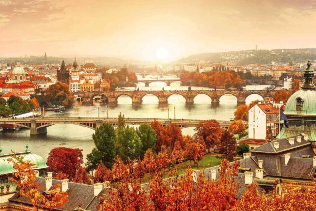 an autumn view of Prague, the Charles Bridge and the Vltava River.