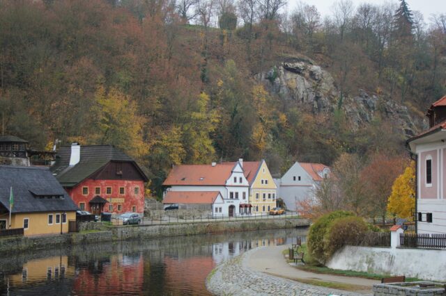 A line of pretty houses along the side of the Vltava River in Český Krumlov, Czech Republic.